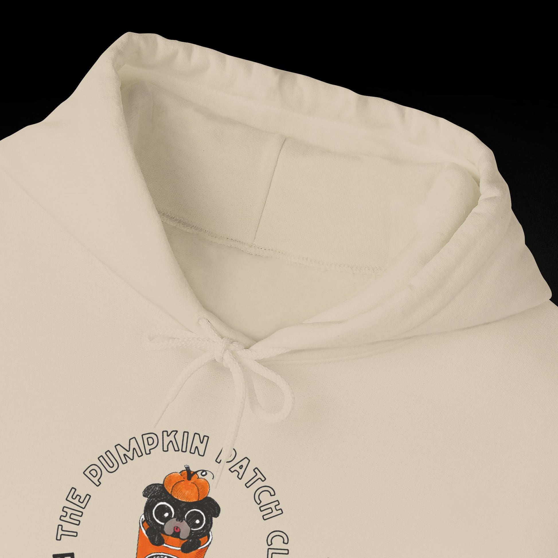 A white hoodie with a graphic design featuring a cartoon character wearing a pumpkin hat.