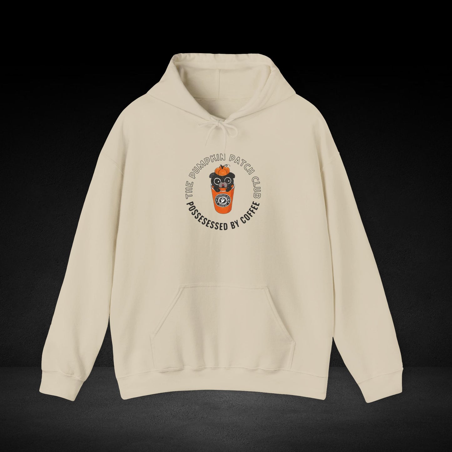 A beige hoodie with a graphic design on the front, featuring a cartoon character wearing a coffee cup and the text "The Pumkin Patch Club" around the design.