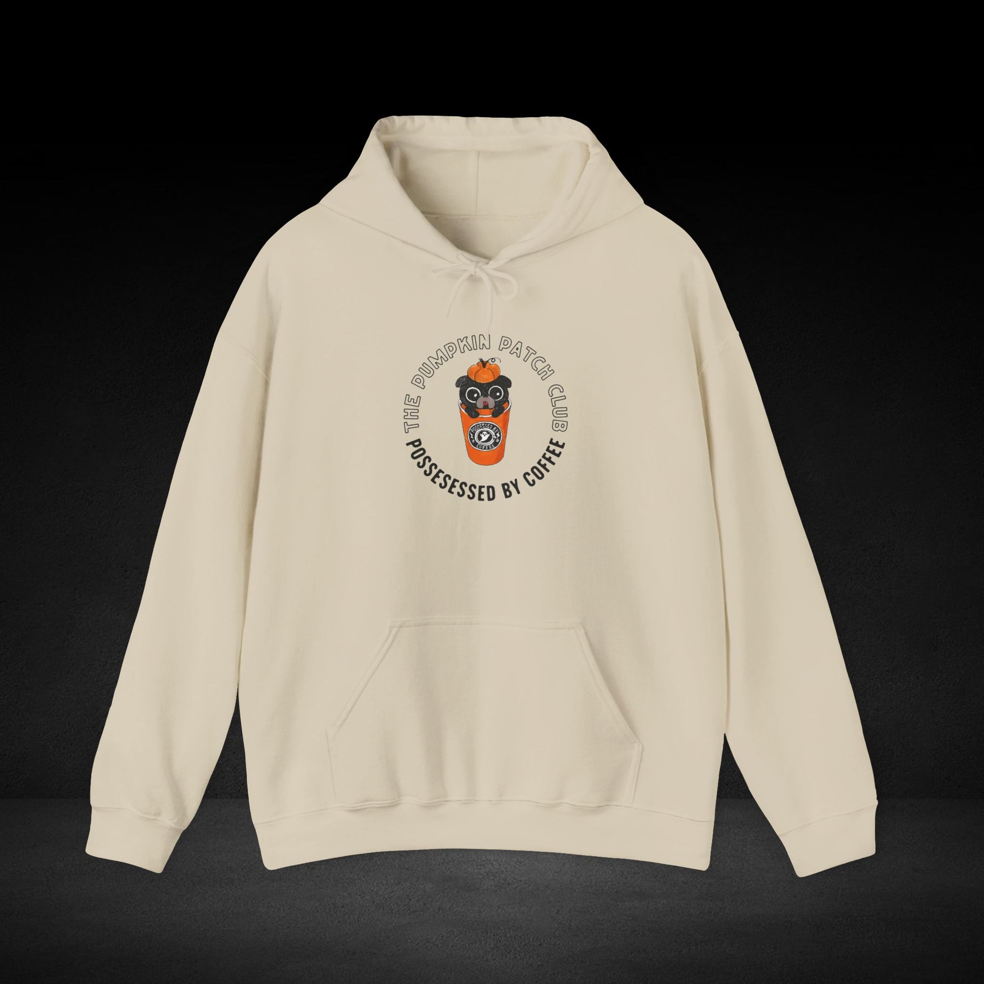 A beige hoodie with a graphic design on the front, featuring a cartoon character wearing a coffee cup and the text "The Pumkin Patch Club" around the design.