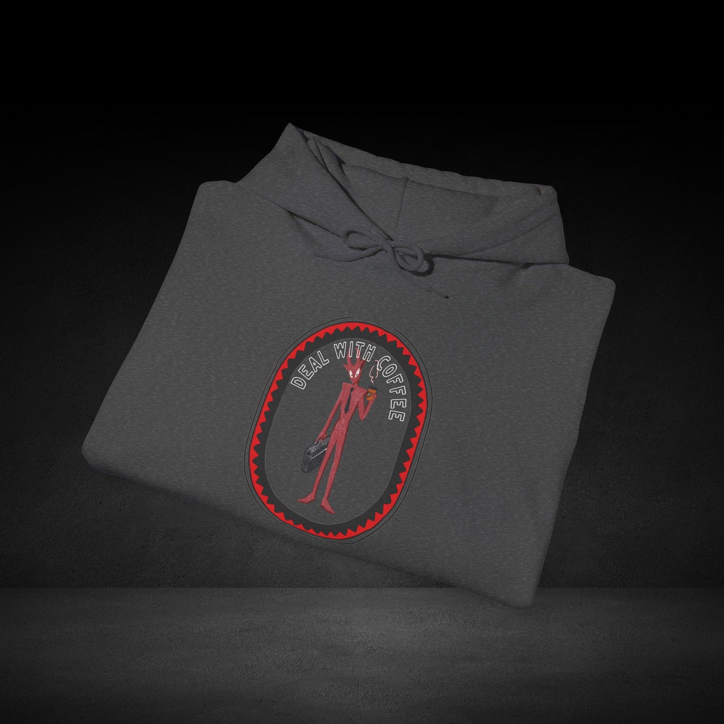 A gray hoodie with a red and black graphic design on it, featuring a figure holding a coffee cup.