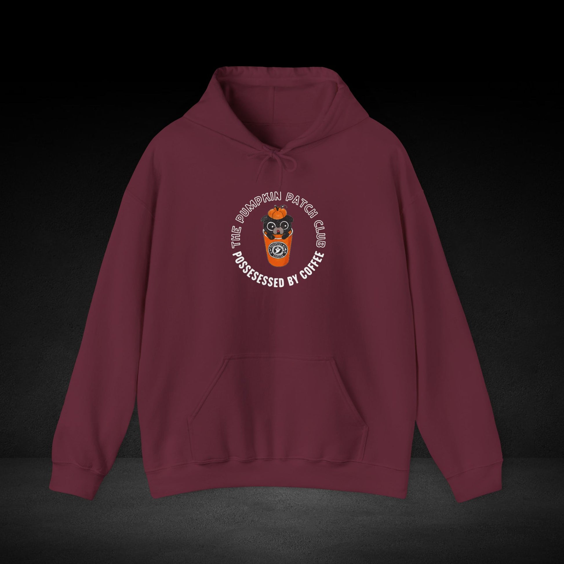 A burgundy hoodie with a graphic design on the front, featuring a character wearing a mask and the text "The Pumpkin Patch Club" around a circular logo.