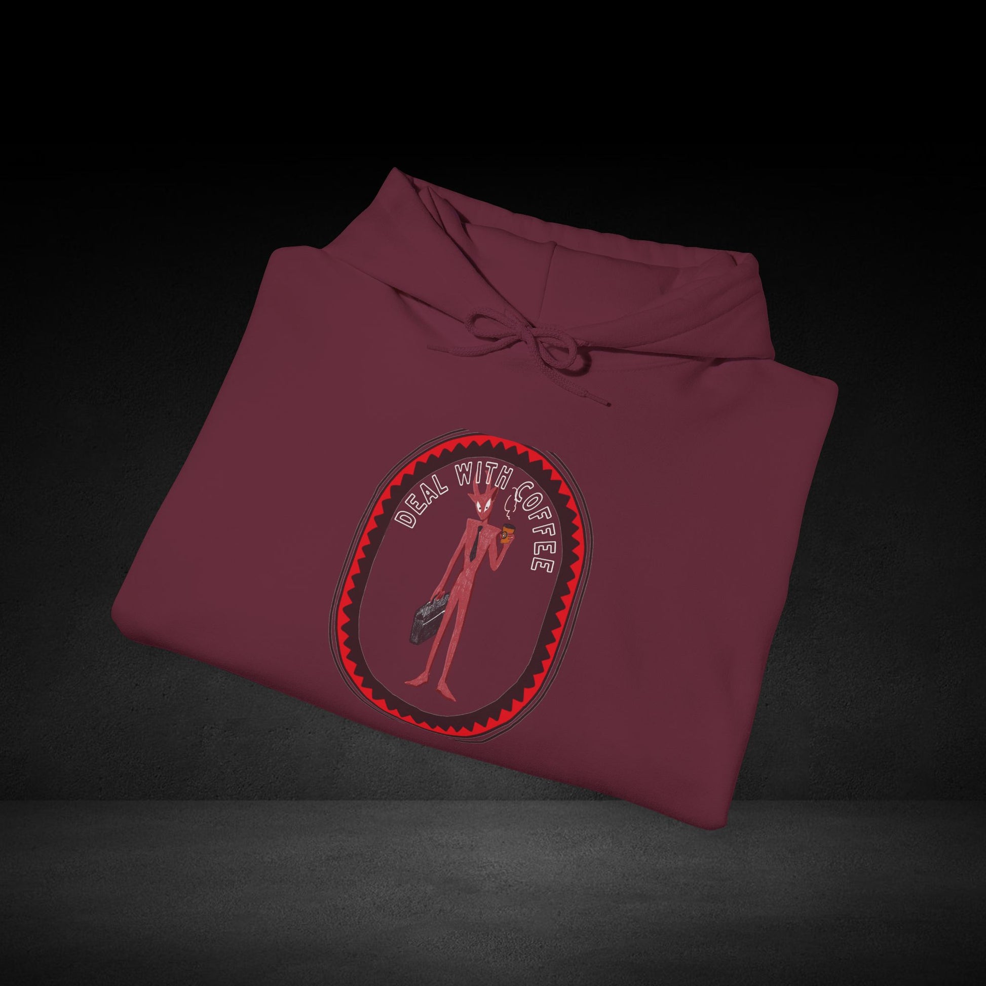 A maroon hoodie with a graphic design on the front, featuring a stylized figure holding a weapon.