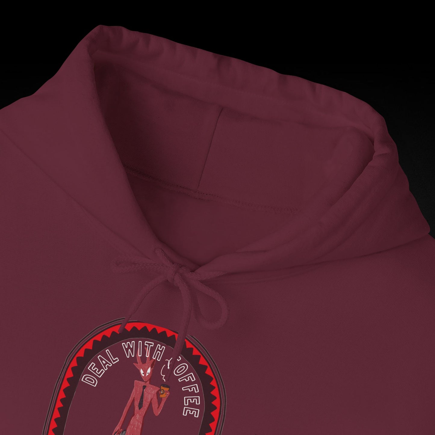 A close-up view of a burgundy hoodie with a graphic design on the front.